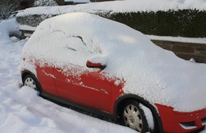 snow covered red car