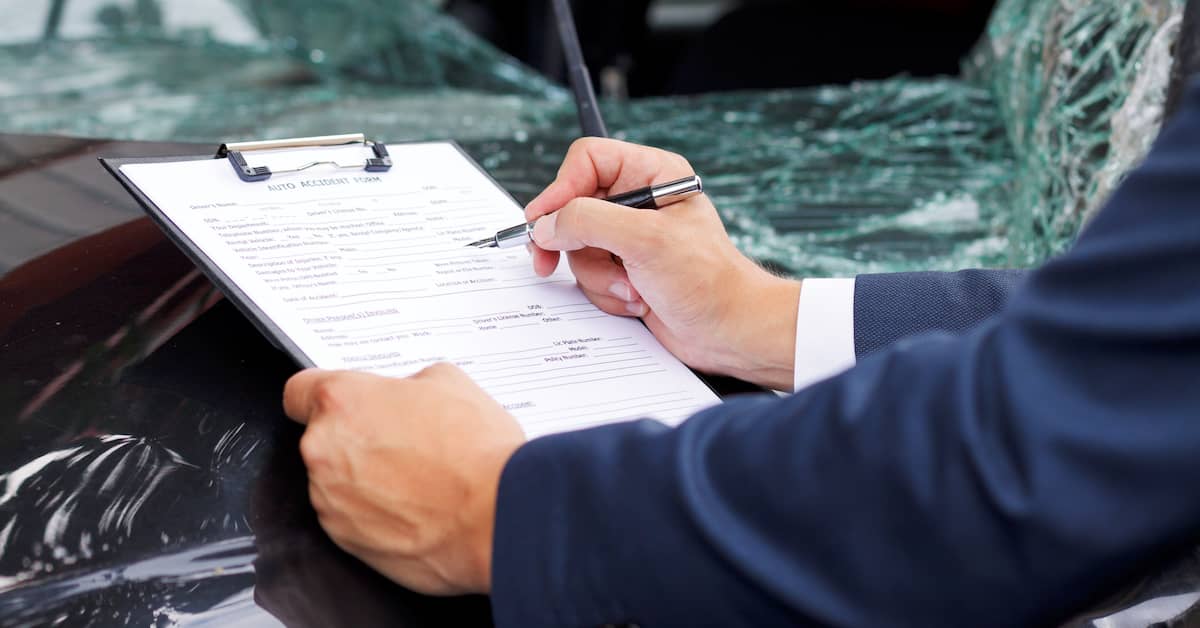 Man completing car accident case paperwork | Hauptman, O'Brien, Wolf & Lathrop