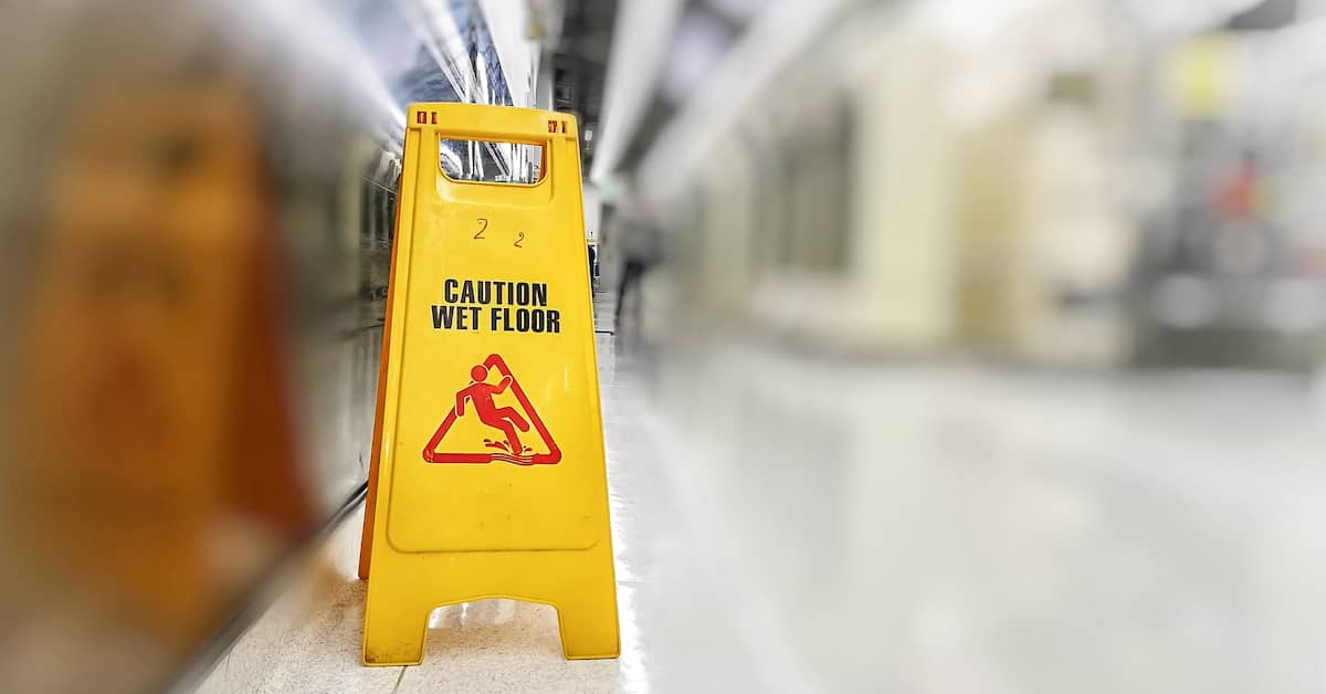 sign reading Caution: Wet Floor in commercial establishment