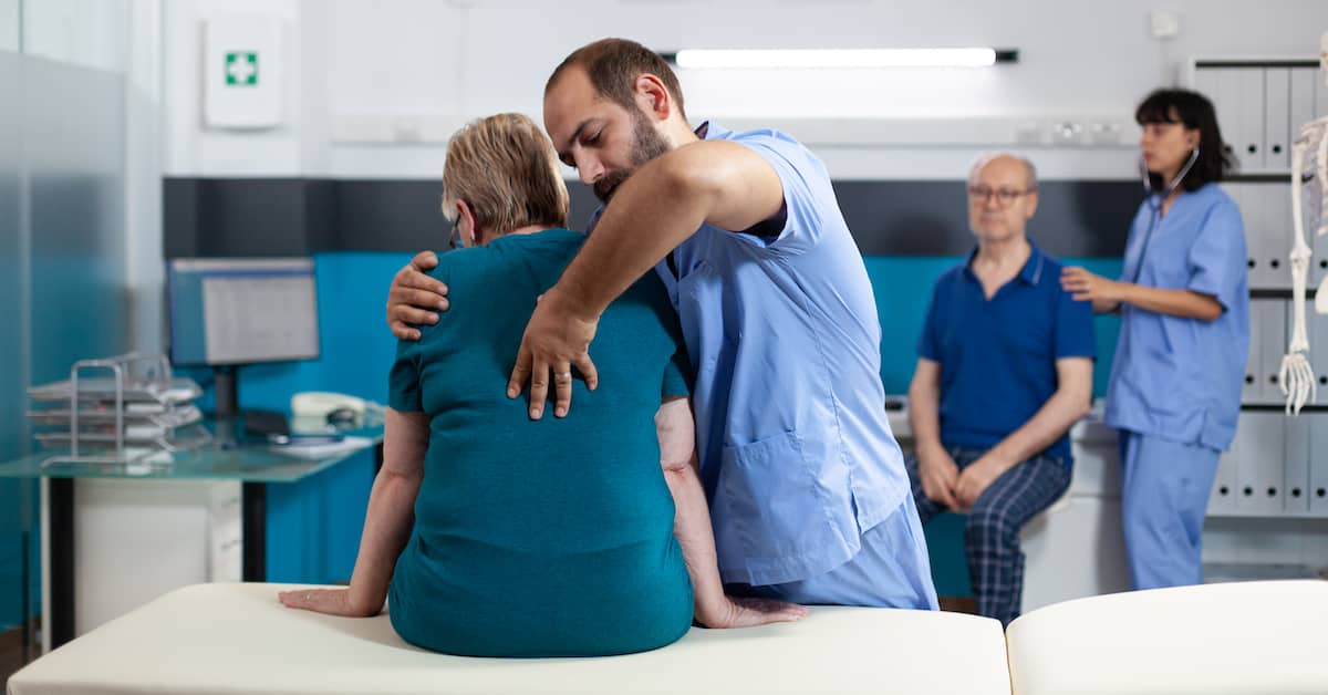 medical professionals assisting woman with spinal injury