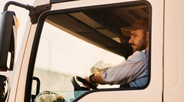 truck driver behind the wheel of a semi-truck