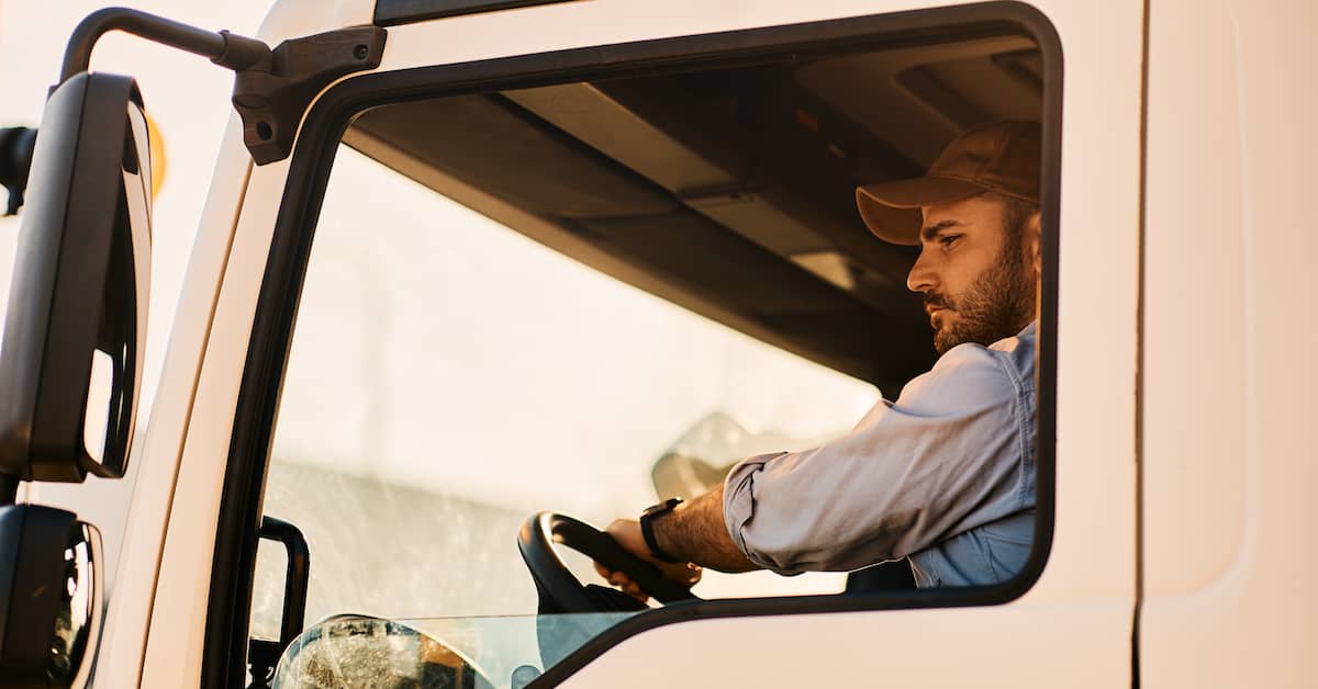 truck driver behind the wheel of a semi-truck