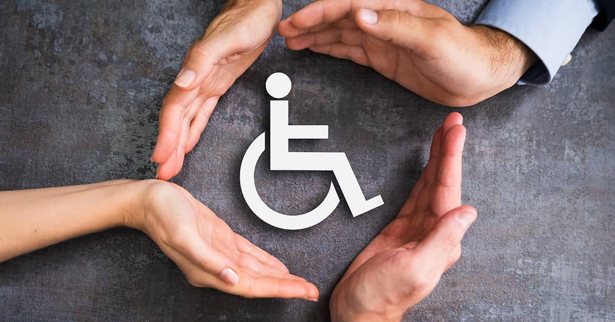 Hands enclosing a symbol for a person in a wheelchair | Hauptman, O'Brien, Wolf & Lathrop