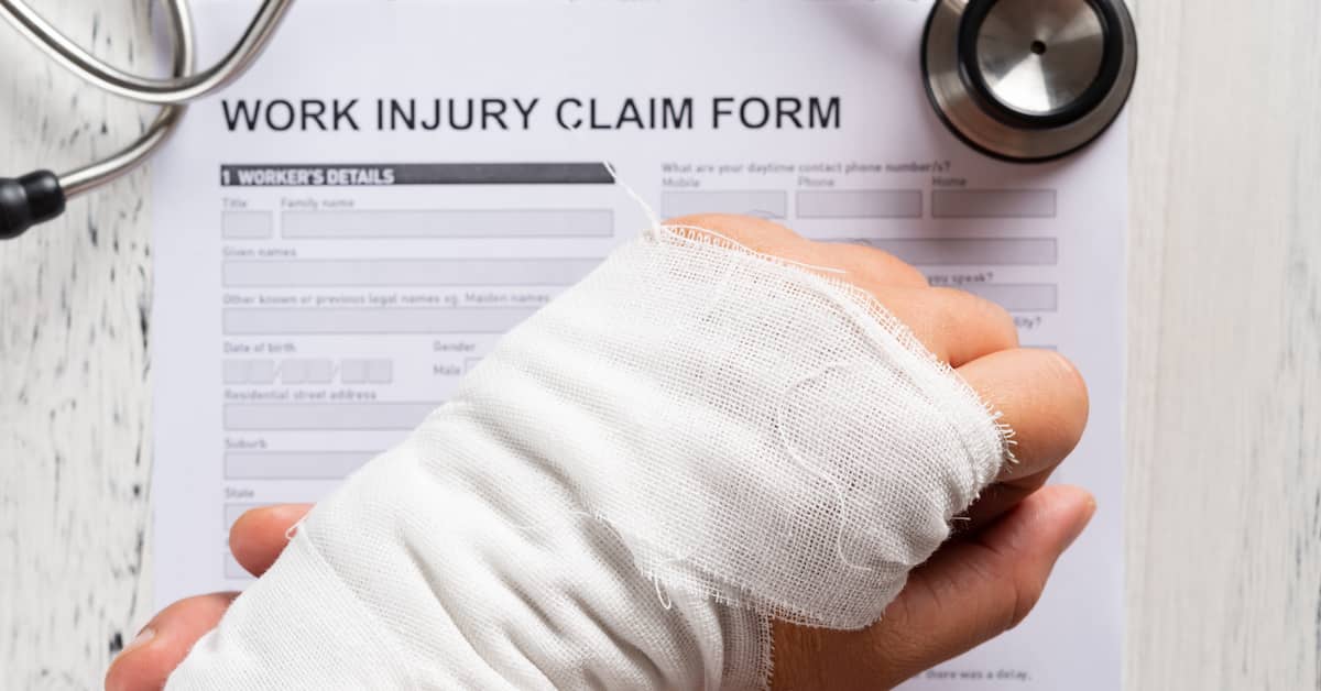 Worker with wrist injury filling out Work Injury Claim Form | Hauptman, O'Brien, Wolf & Lathrop