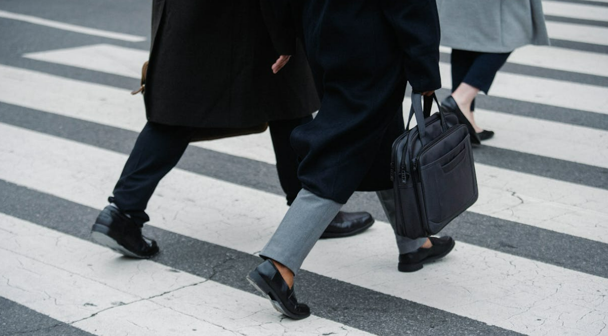 People walking on a pedestrian crossing.