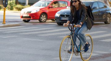 A cyclist riding without a helmet.