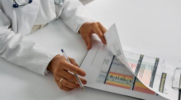 Doctor examining the medical records of a patient.
