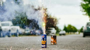 Set off fireworks on a street.