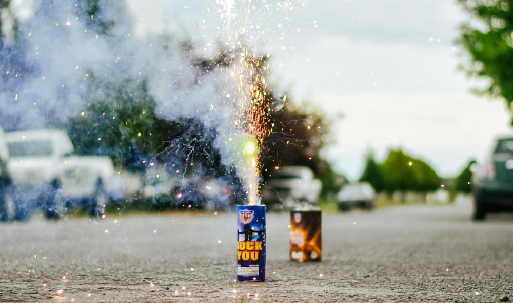 Set off fireworks on a street.
