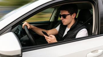 Driver texting on his phone while speeding.
